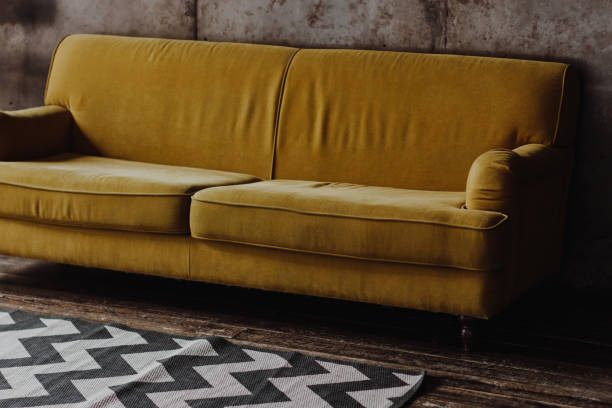 istock Yellow velvet couch in loft room 1203045740