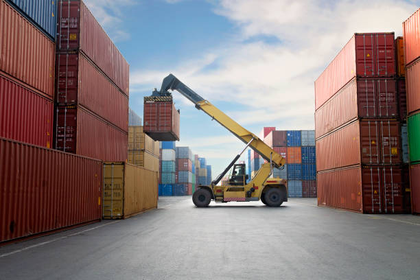 istock Crane lifting up container in a port. 1203046615