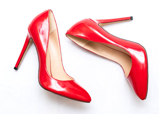 istock beautiful female shiny red stilettos on a white background 1203047010