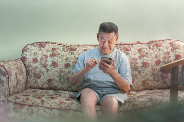 istock Happy senior man using smart phone at home 1203047624