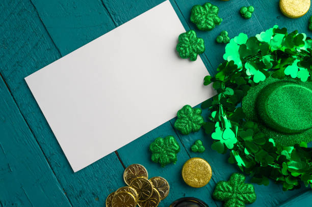 istock St. Patrick's Day background for congratulation, greeting card for design. Leprechaun coins, clover and hat. 1203047629