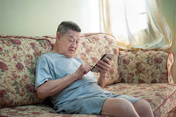 istock Happy senior man using smart phone at home 1203047632