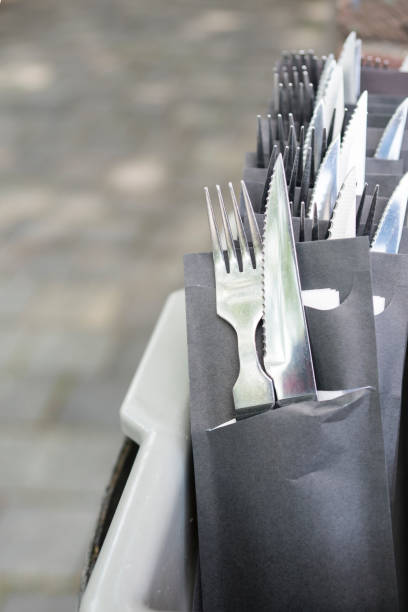 istock Knife and fork in black paper bag 1203048301