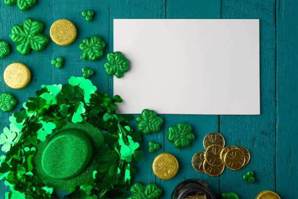 istock St. Patrick's Day background for congratulation, greeting card for design. Leprechaun coins, clover and hat. 1203048406