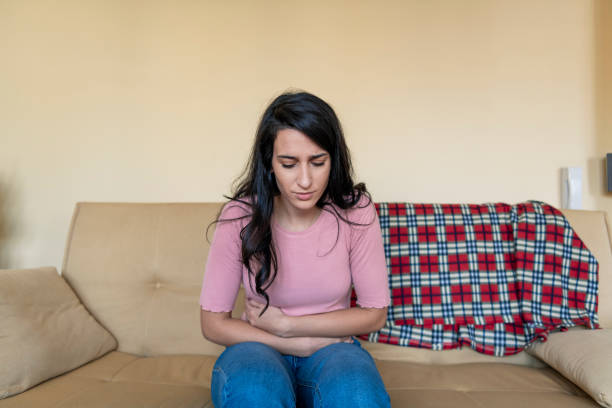 istock Woman having painful stomachache on bed 1203048805