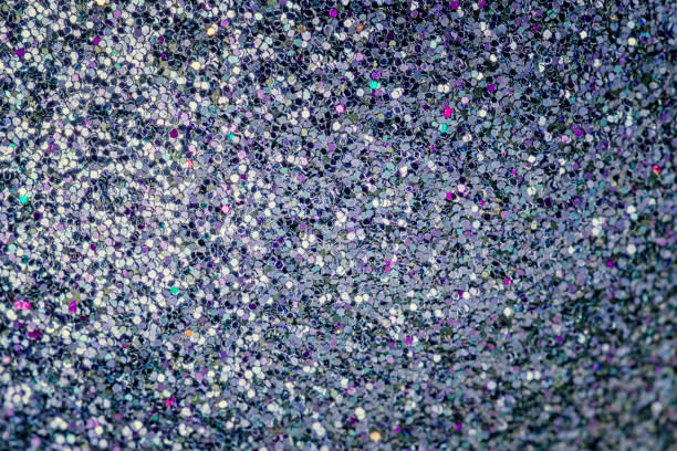 istock Bright shiny background from many small sparkles close-up. Dark blue background with colored splashes for sites and layouts. 1203049771
