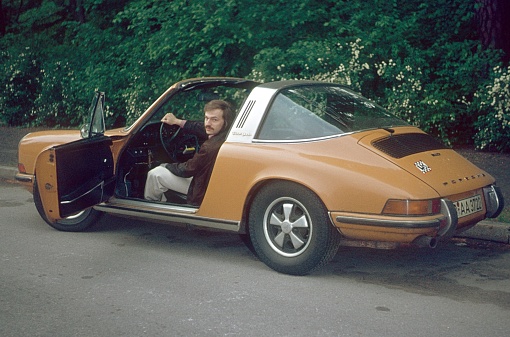 Berlin (West), Germany, 1974. Porsche driver is waiting for his passenger.