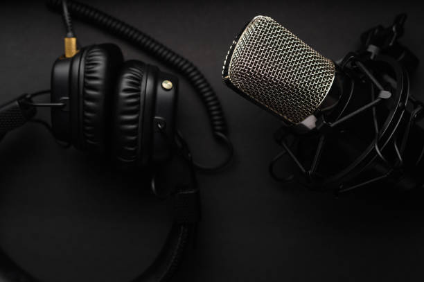 istock Podcasts and Stream. Flat lay. Studio condenser microphone black with professional headphones 1203054676