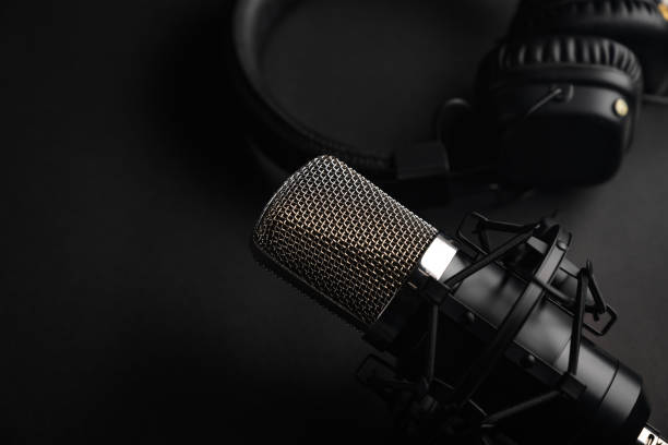istock Podcasts and Stream. Flat lay. Studio condenser microphone black with professional headphones, top view with space for design. 1203054846