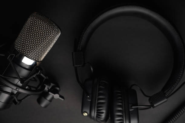 istock Podcasts and Stream. Flat lay. Studio condenser microphone black with professional headphones 1203054973