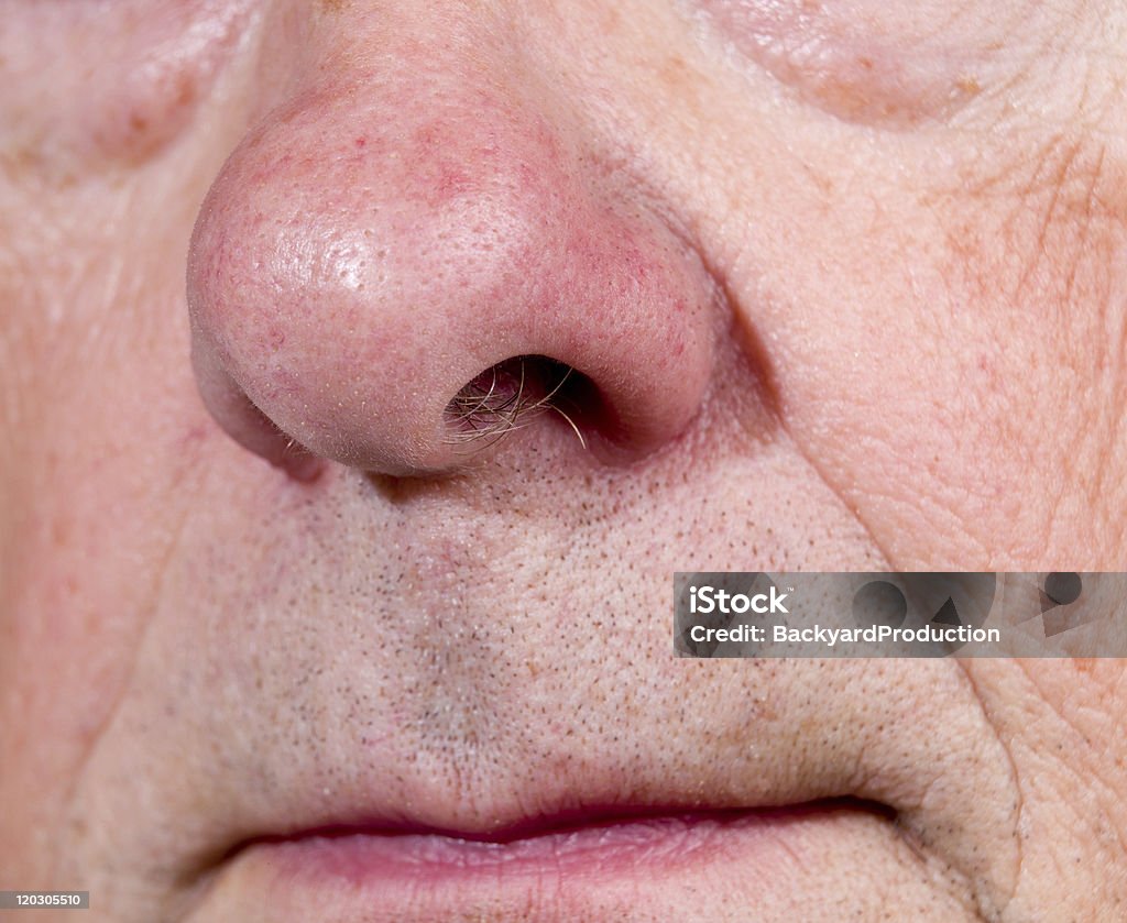 Extreme close up of senior nose in side view Front view of mature man's nose and upper lip with the mouth just visible Adult Stock Photo