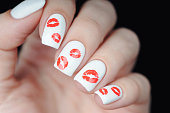 White manicure on St. Valentine s Day with red lips pattern