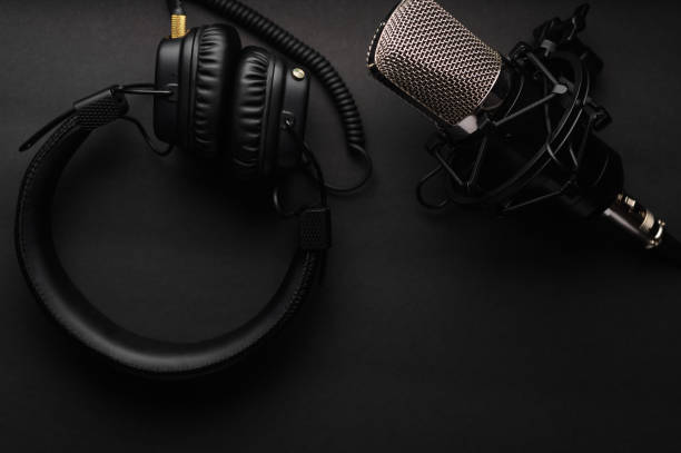 istock Podcasts and Stream. Flat lay. Studio condenser microphone black with professional headphones 1203056500