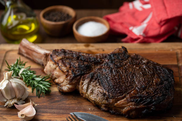 istock grilled tomahawk steak on wooden plate ready for eat 1203057450