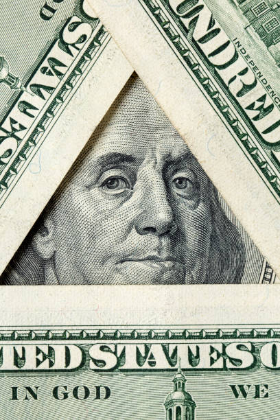 istock Triangle made of $100 bills with Benjamin Franklin inside 1203059041