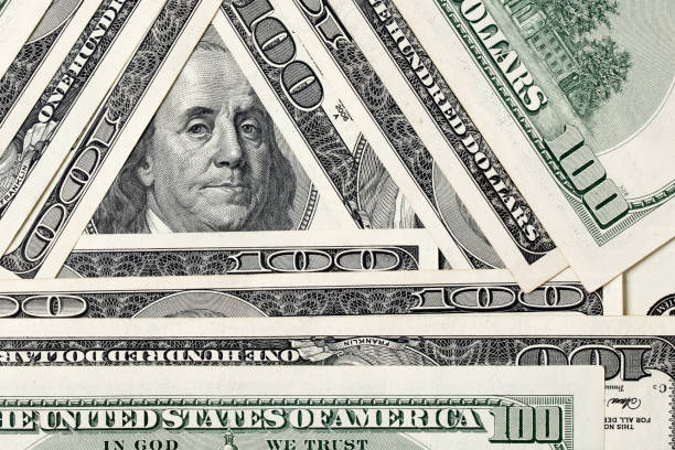 istock Triangle made of $100 bills with Benjamin Franklin inside 1203060694