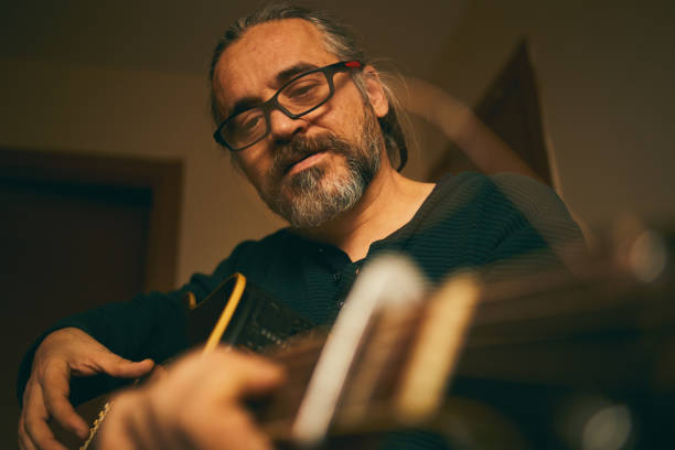 istock A man is working at home with guitar exercise 1203061687