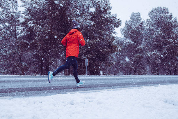 istock Running girl in the snow 1203062188