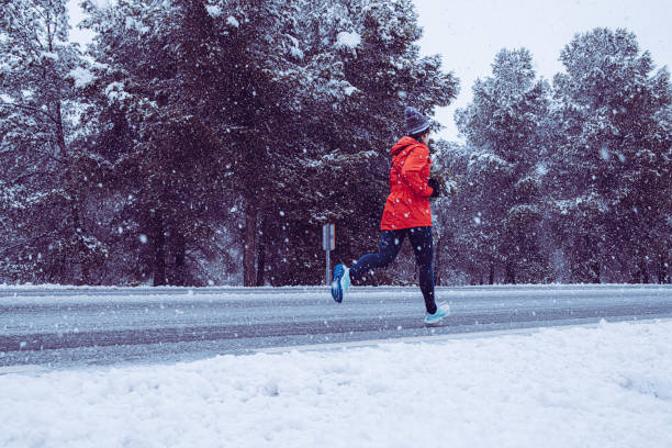 istock Running girl in the snow 1203062234