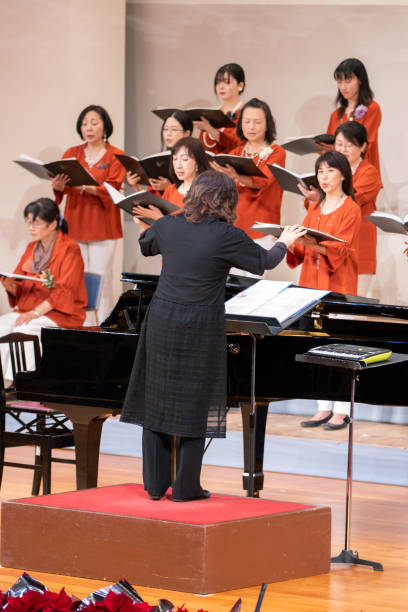 istock musical conductor leading women't chorus at concert 1203062248