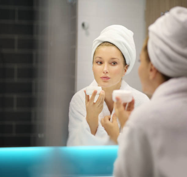 istock Magic anti-aging cream.Applying the cream 1203067456