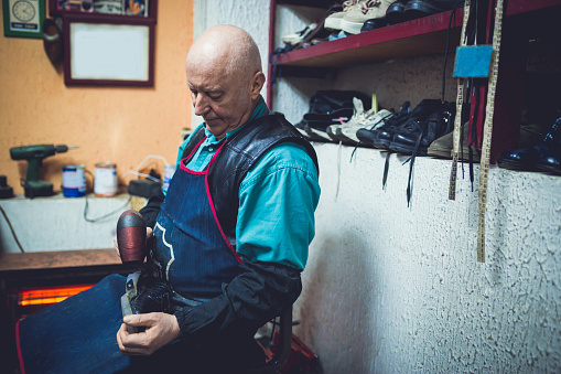 Senior man working at the shoe shop