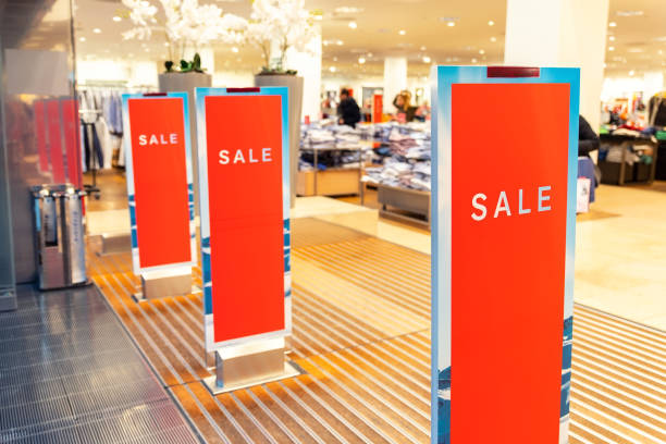 red bright sale banner on anti-thieft gate sensor at retail shopping mall entrance. seasonal discount offer in store - store indoors design advertisement imagens e fotografias de stock