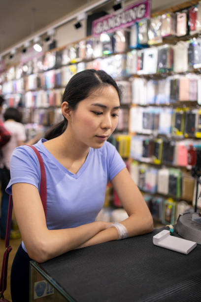 istock Young woman standing at shop counter 1203073475