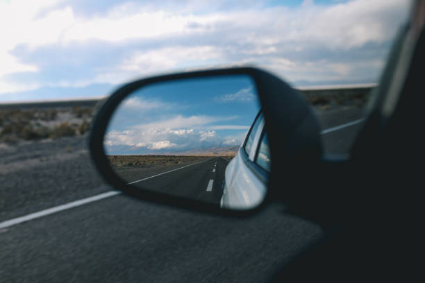 istock Wing mirror view of a road trip 1203074201