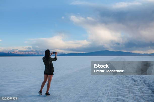 Woman Taking Photos In The Salt Desert In Argentina Stock Photo - Download Image Now