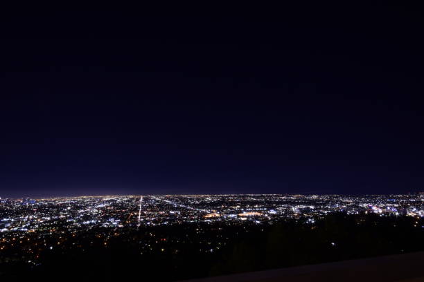 istock Dramatic Wide Angle View Of Sprawling Illuminated Los Angeles Metropolis Horizon During Beautifully Vivid Twilight Sky 1203075662