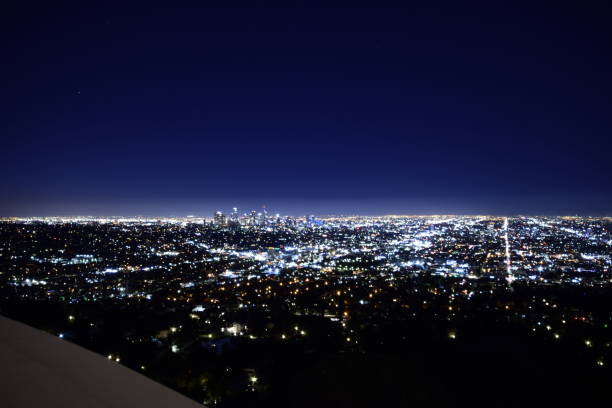 istock Dramatic Wide Angle View Of Sprawling Illuminated Los Angeles Metropolis Horizon During Beautifully Vivid Twilight Sky 1203076203