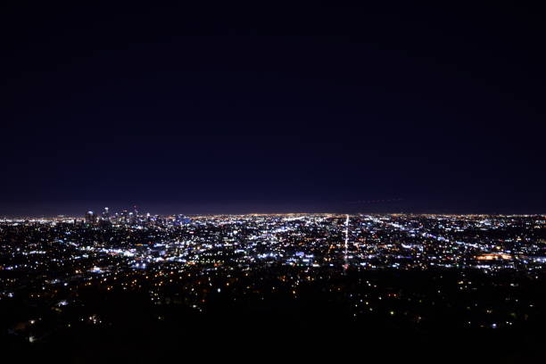 istock Dramatic Wide Angle View Of Sprawling Illuminated Los Angeles Metropolis Horizon During Beautifully Vivid Twilight Sky 1203076214