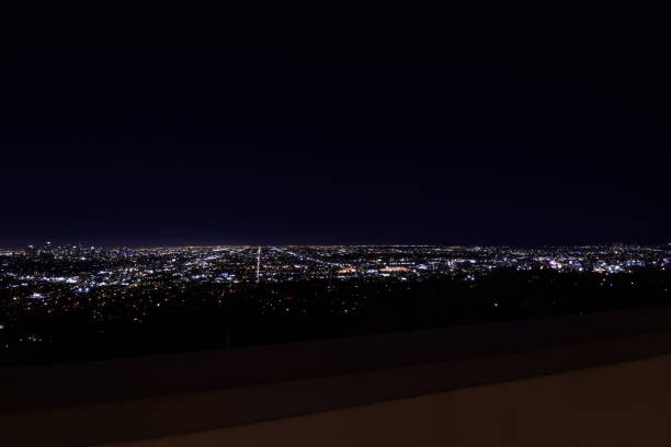 istock Dramatic Wide Angle View Of Sprawling Illuminated Los Angeles Metropolis Horizon During Beautifully Vivid Twilight Sky 1203076223