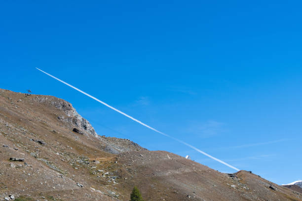 Condensation trail of a passing jet in the Aps.