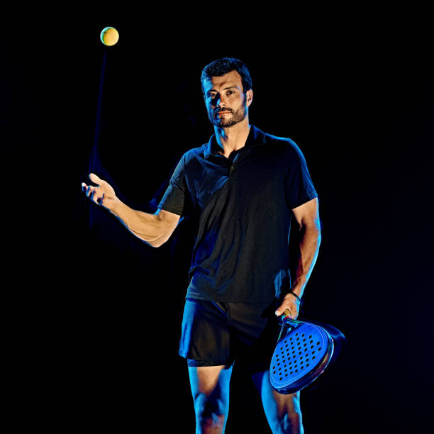istock Paddle tennis player man light painting isolated black background 1203077442