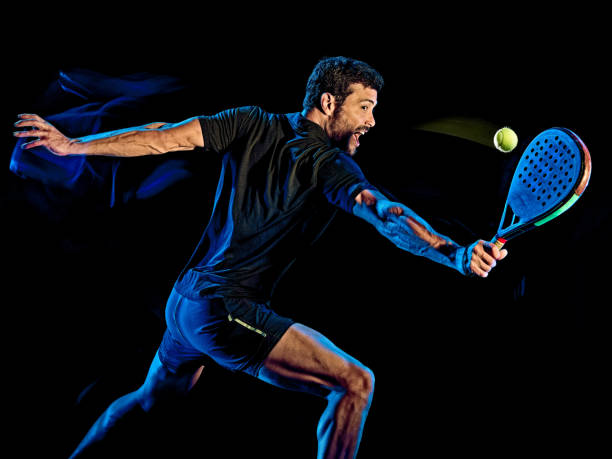 istock Paddle tennis player man light painting isolated black background 1203077448