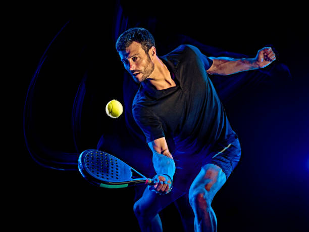 istock Paddle tennis player man light painting isolated black background 1203077456