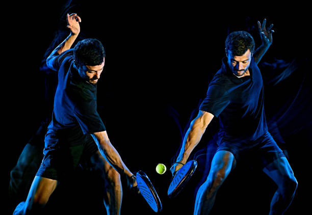 istock Paddle tennis player man light painting isolated black background 1203077476