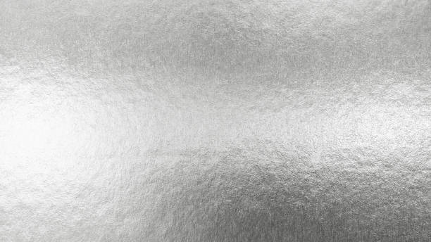 istock Silver background metallic texture wrapping foil paper shiny white grey metal backdrop for wall paper decoration element 1203078306