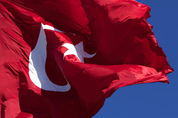 istock Sunlight Turkish flag waving in wind at sunny day 1203078693