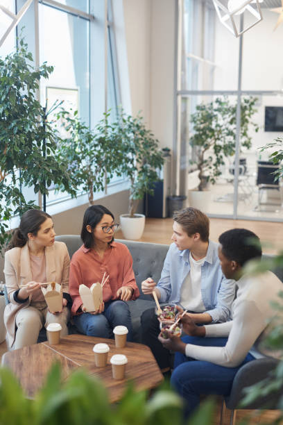 istock Group of Young People Enjoying Lunch in Office 1203080804