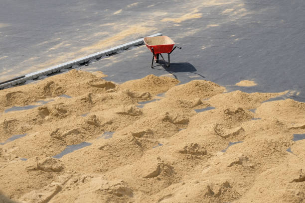 istock Red wheelbarrow with one wheel on the pavement 1203081717
