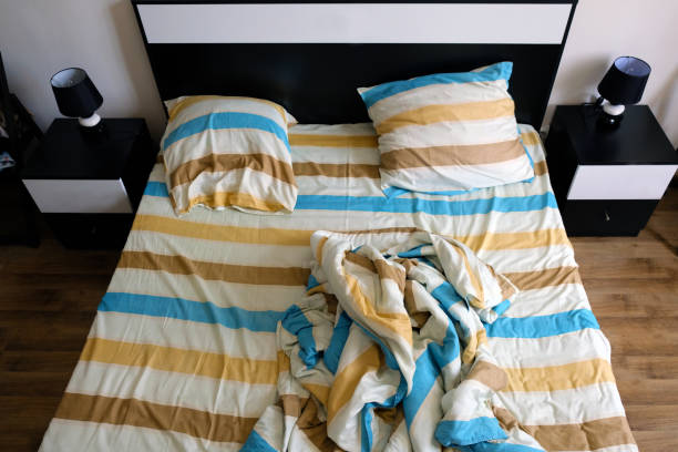 istock Striped sheets, pillows and duvet cover on the bed top view. 1203081958