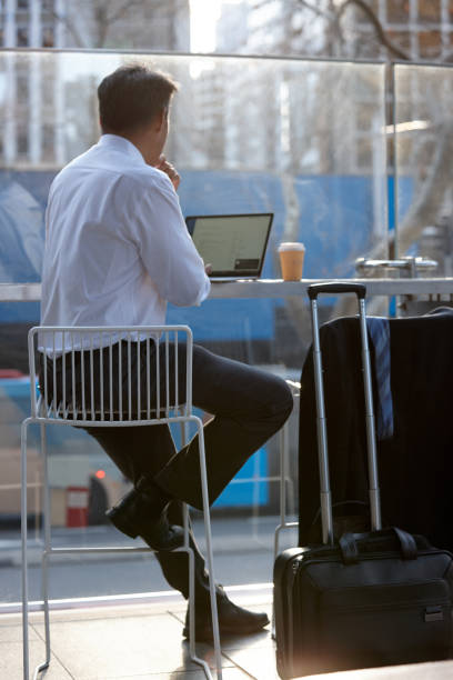 istock Australasian businessman working on laptop outside 1203082182