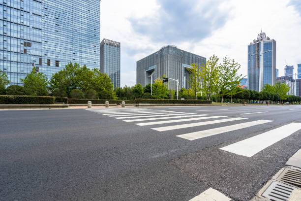 istock empty road with zebra crossing and skyscrapers in modern city 1203086763