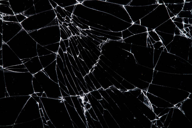istock cracked glass isolated on a black background. 1203089791