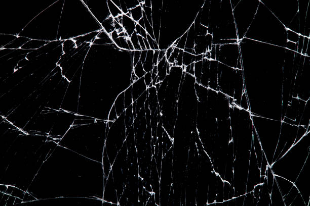 istock cracked glass isolated on a black background. 1203089794