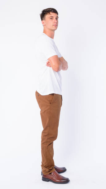 istock Full body shot profile view of young handsome man looking at camera 1203091073