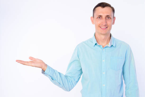 istock Studio shot of happy businessman showing something 1203092061